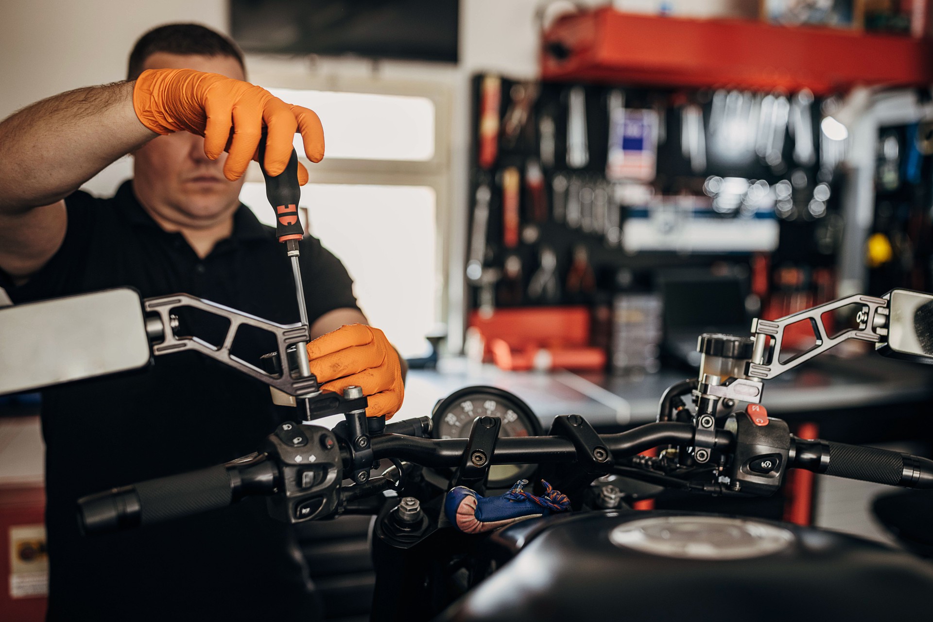Male mechanic repairing motorcycle