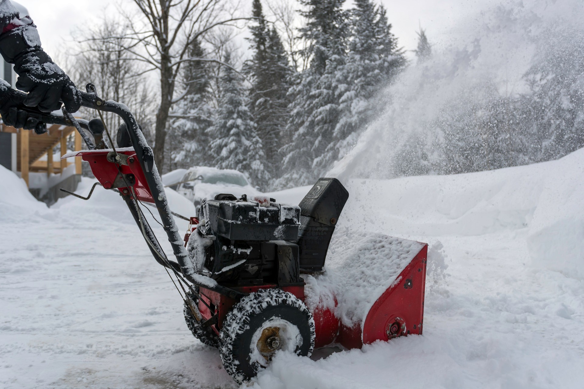 Man Using SnowBlower After a Snowstorm